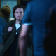 Elisabeth Moss as Kirby Mazrachi in Apple TV+'s Shining Girls, walking through a crowd.